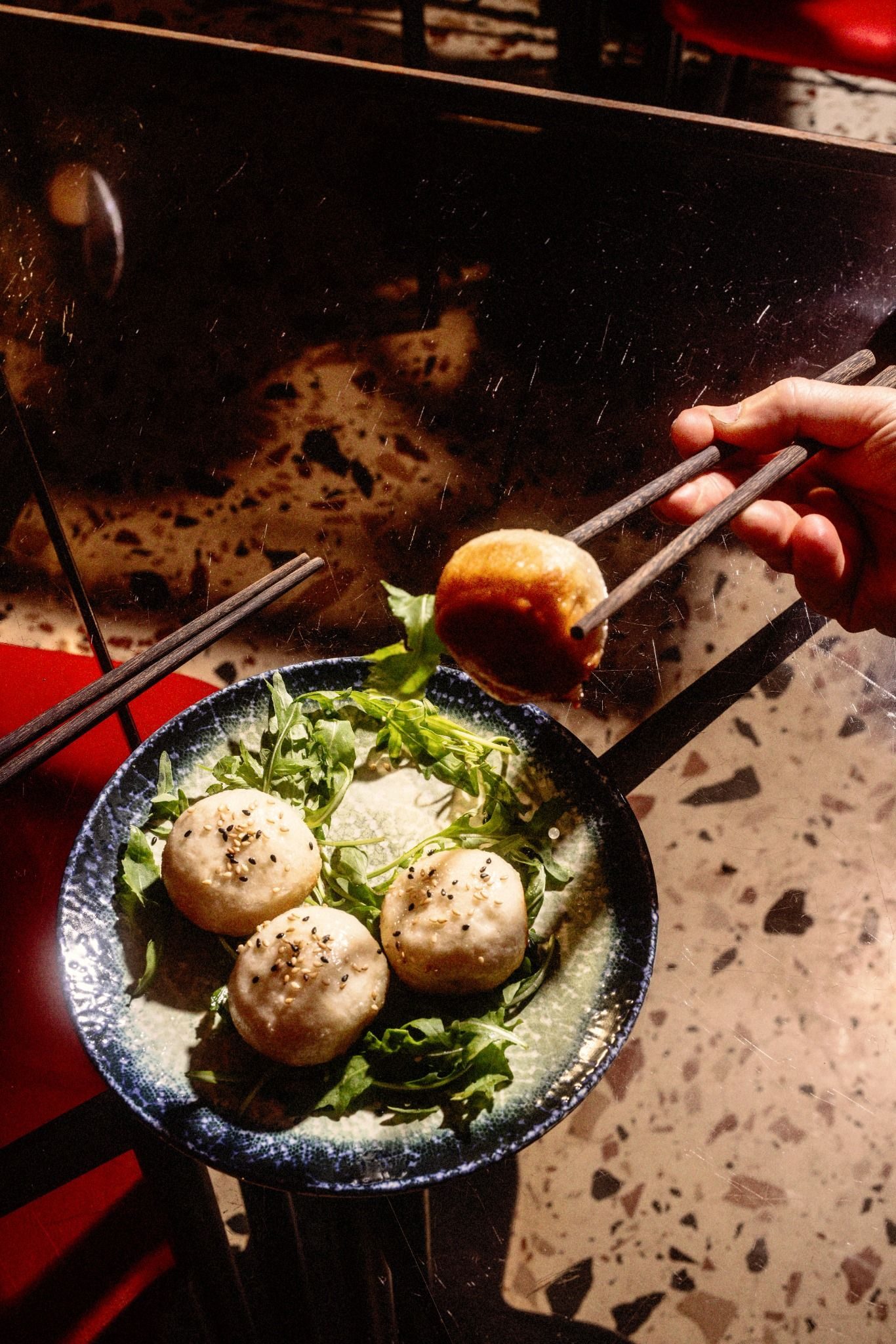 Buns, one lifted with chopsticks