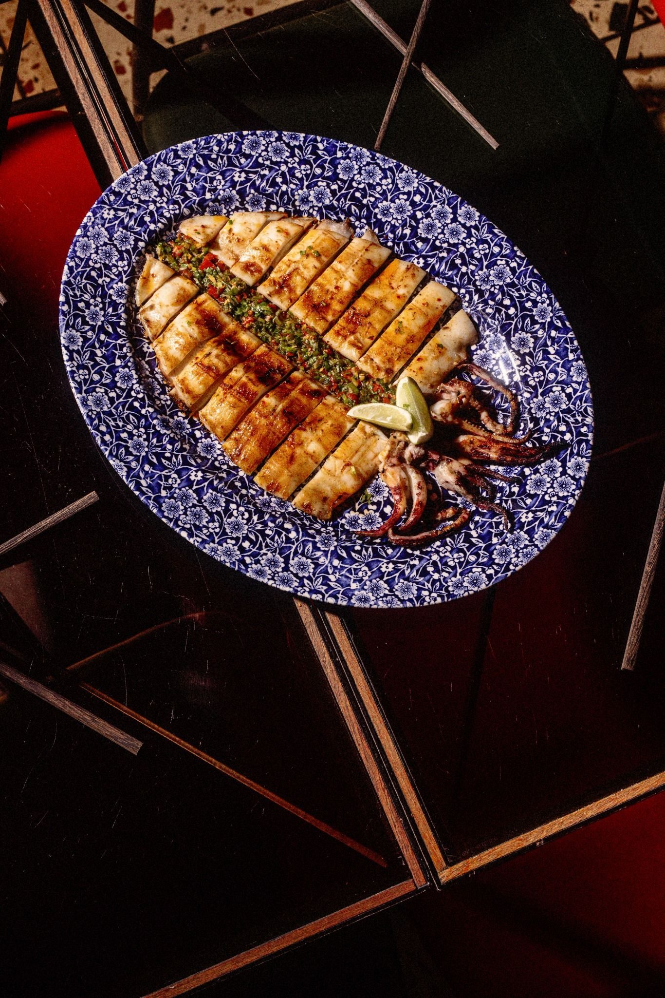 Grilled squid on a blue patterned plate